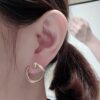 Screenshot Custom Solid 18k Gold Piaget Possession Open Hoop Earrings in 18K Rose Gold Set with 20 Brilliant-Cut Diamonds (approx. 0.20 ct)