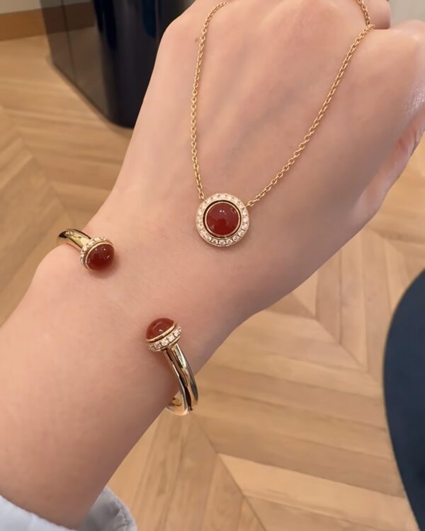 Screenshot Custom Solid 18k Gold Piaget Possession Pendant in 18K Rose Gold Set with 20 Brilliant-Cut Diamonds (approx. 0.28 ct) and Decorated with a Carnelian Cabochon (approx. 0.82 ct) 2 Ways of Wearing